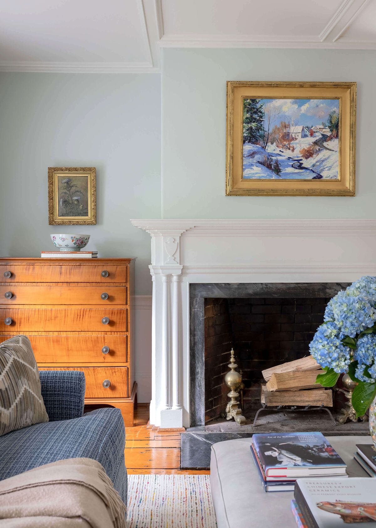 Tiger maple chest beside fireplace