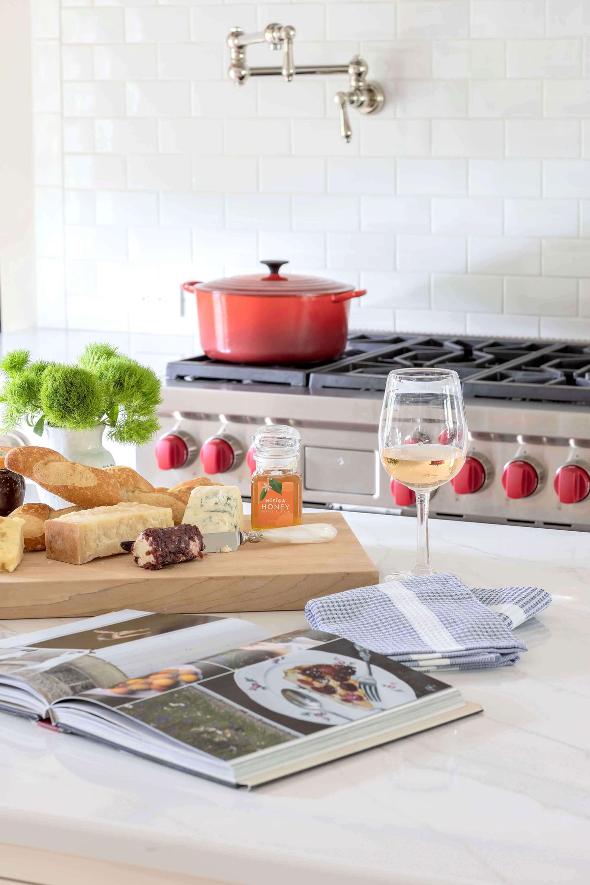 Wine and cheese in gourmet white kitchen