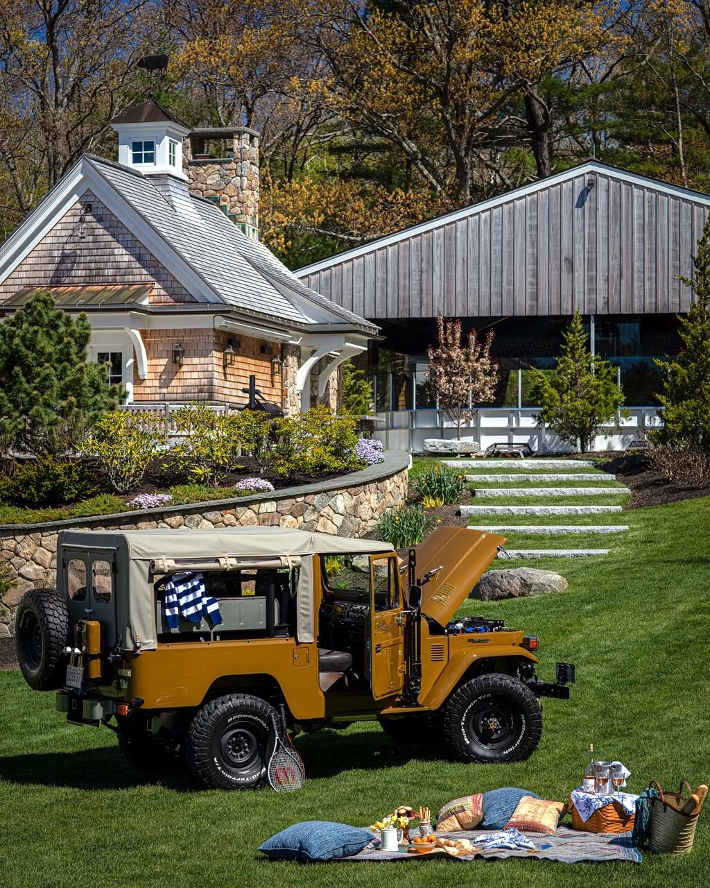 Picnic with vintage car and activities barn in background