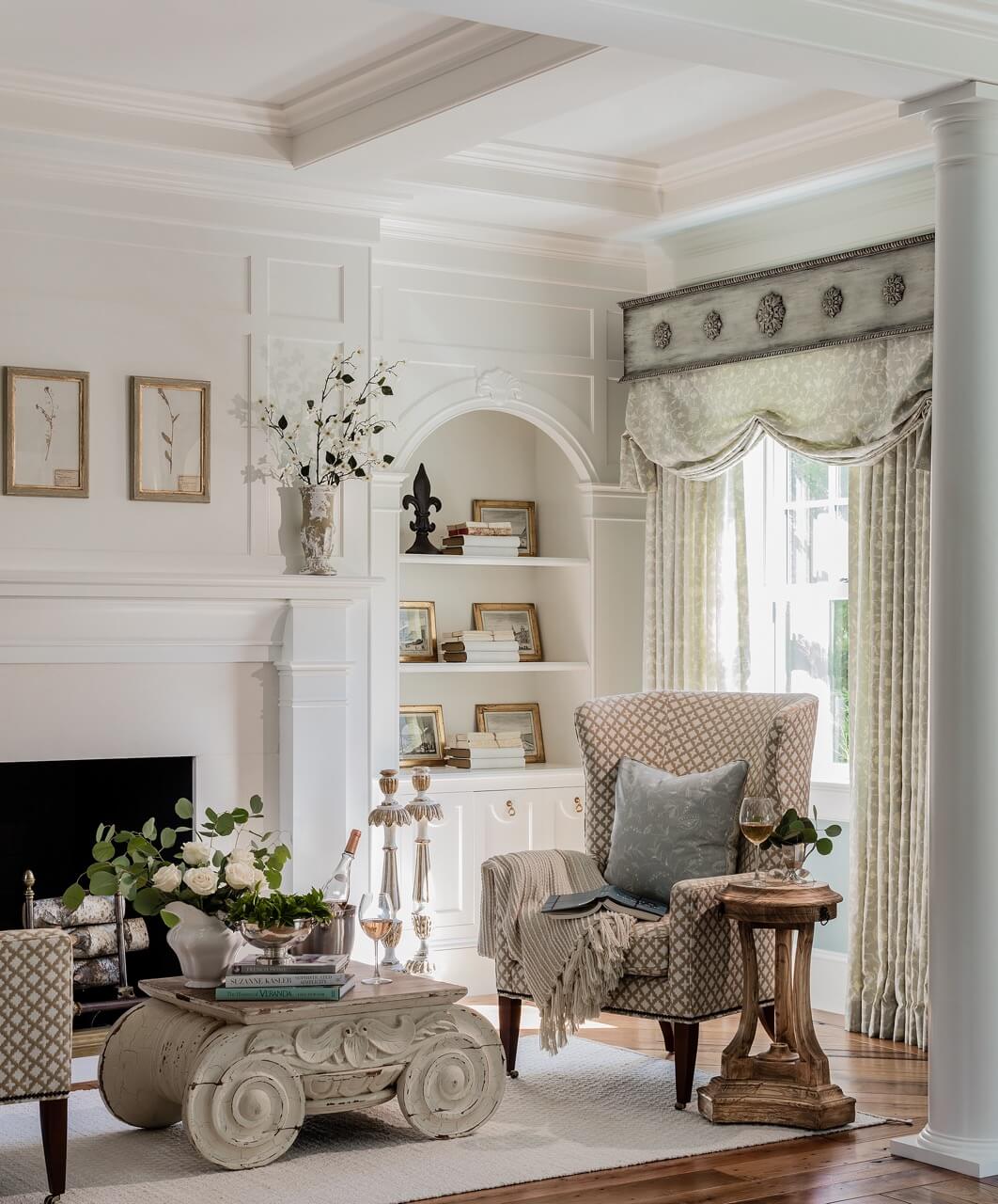 Primary bedroom sitting area with modern wing chair