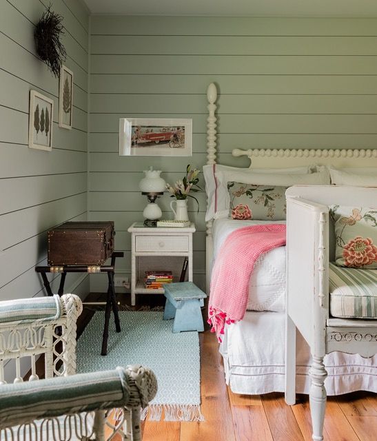 Green and white guest house bedroom