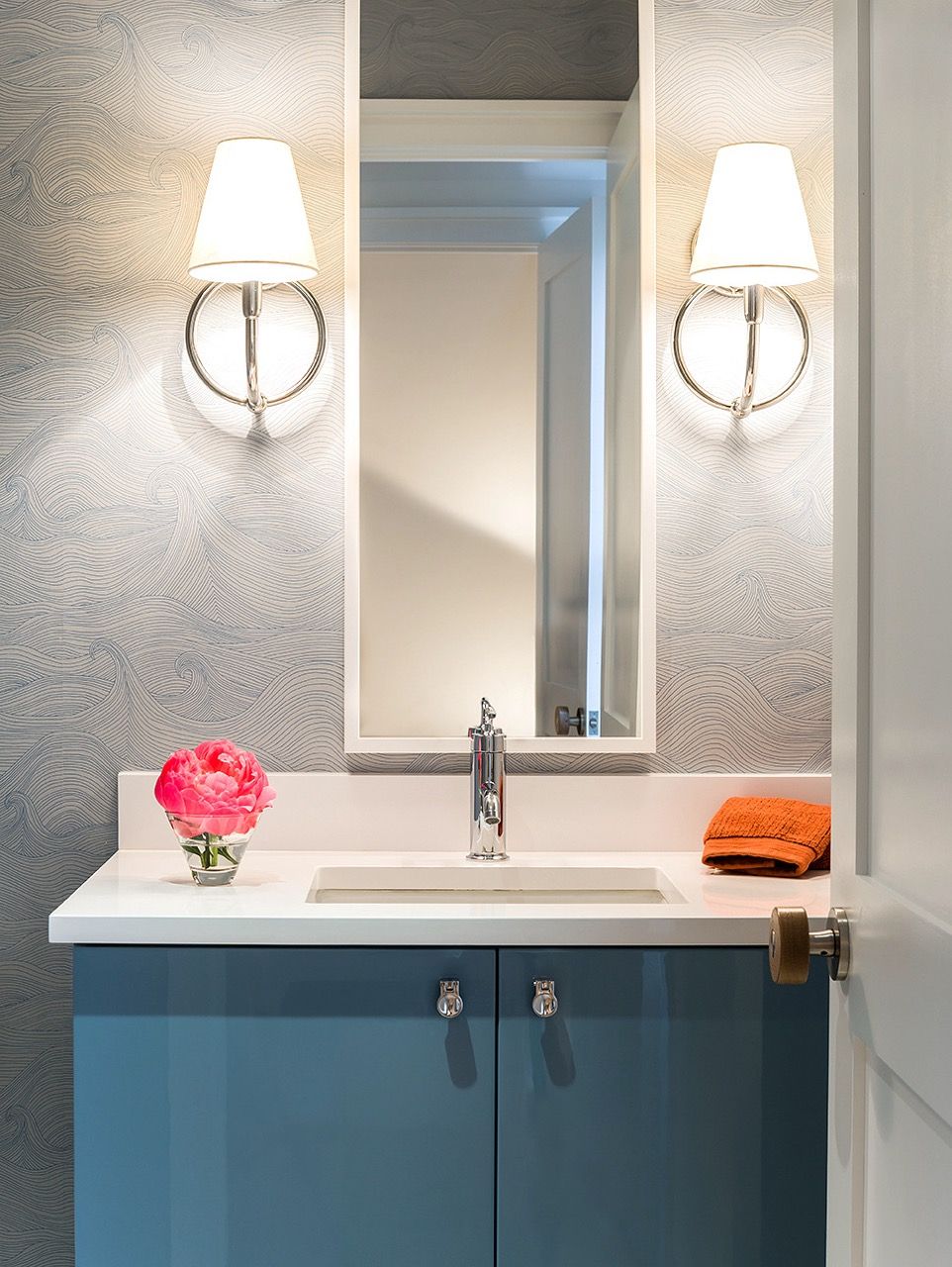 Blue and white powder room with wave wallpaper