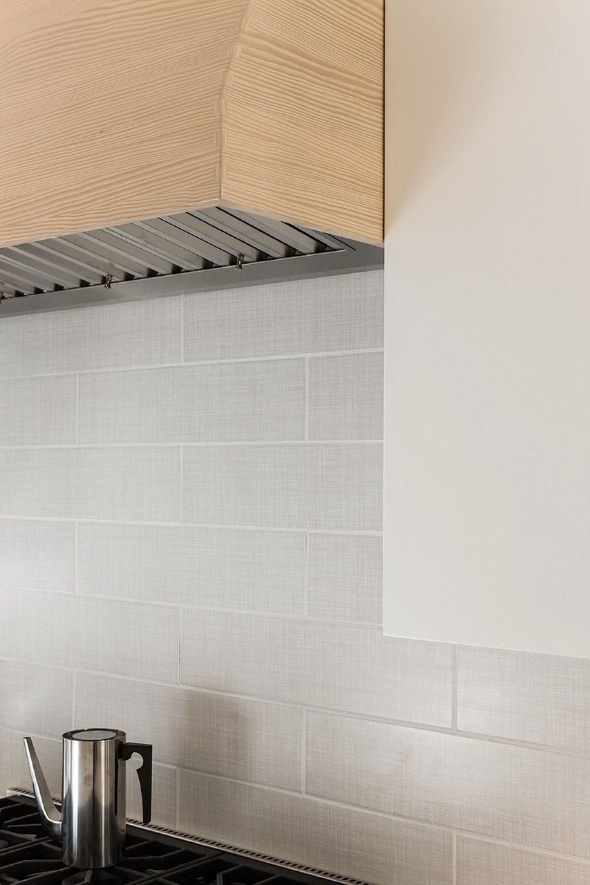 Detail of kitchen wood hood and tile backsplash