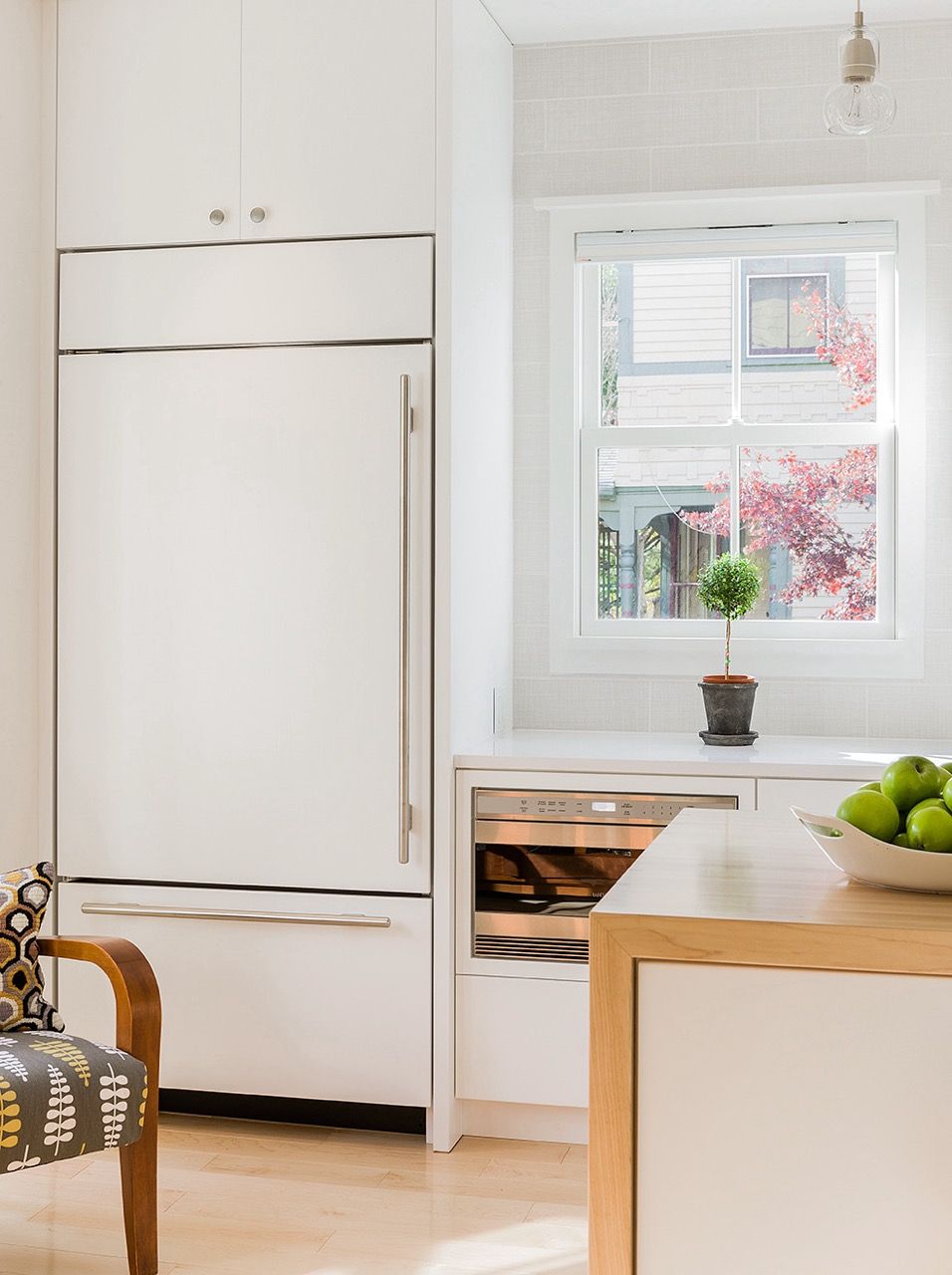 Integrated Sub-Zero refrigerator in white kitchen