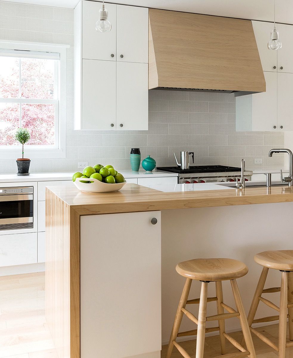 Natural wood hood in white Scandinavian kitchen