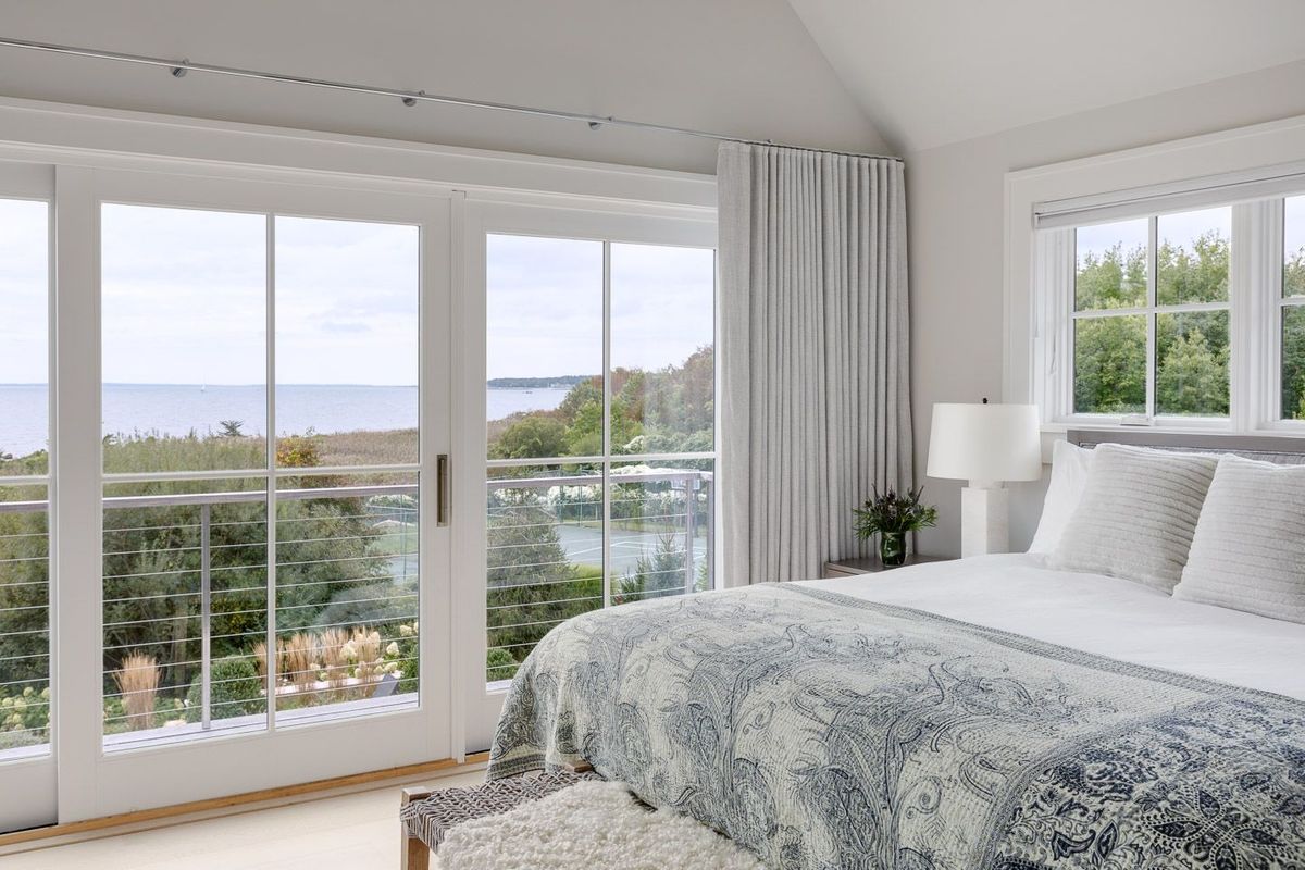 Blue and white bedroom with water view