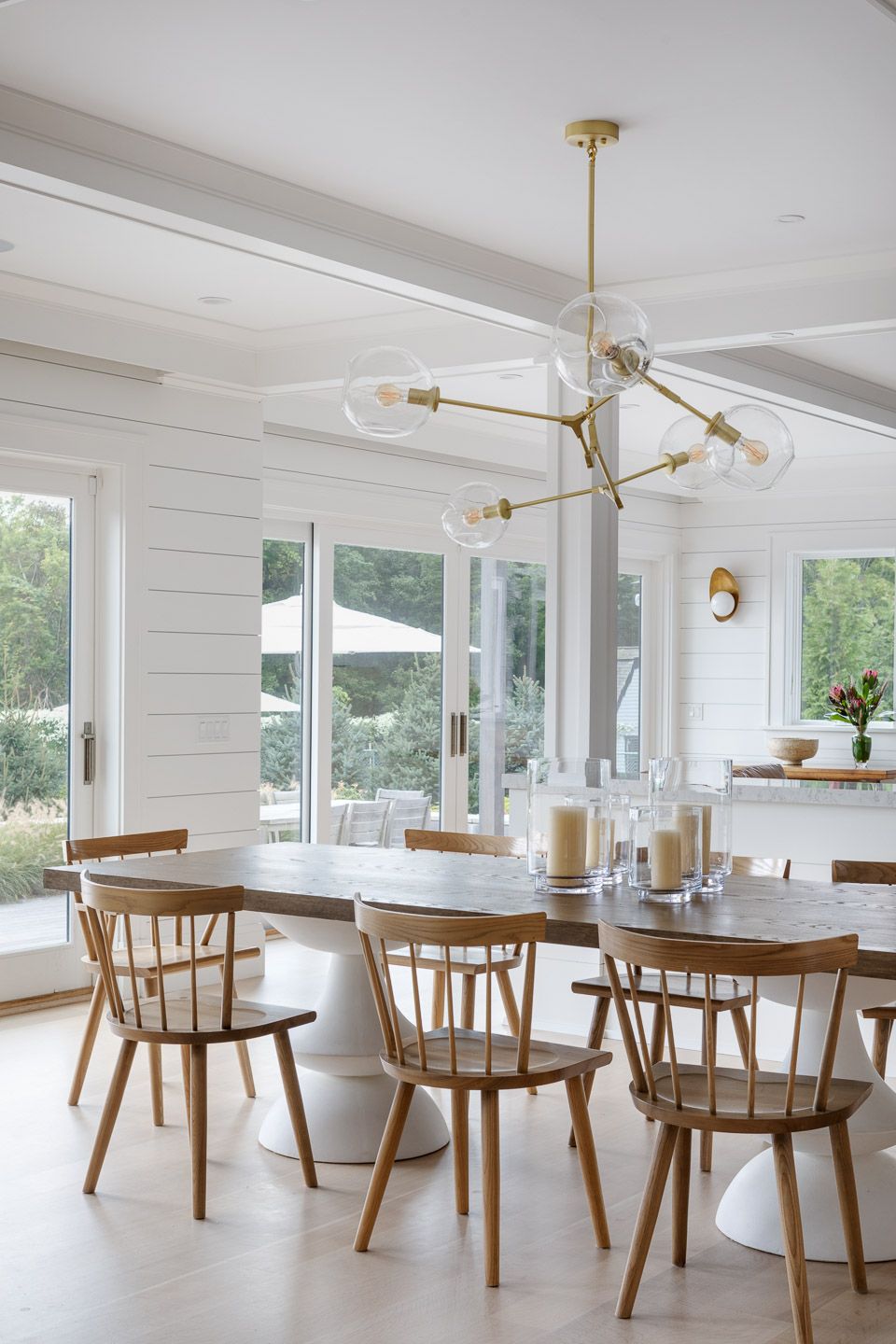 Dining table wiht brass and glass modern chandelier