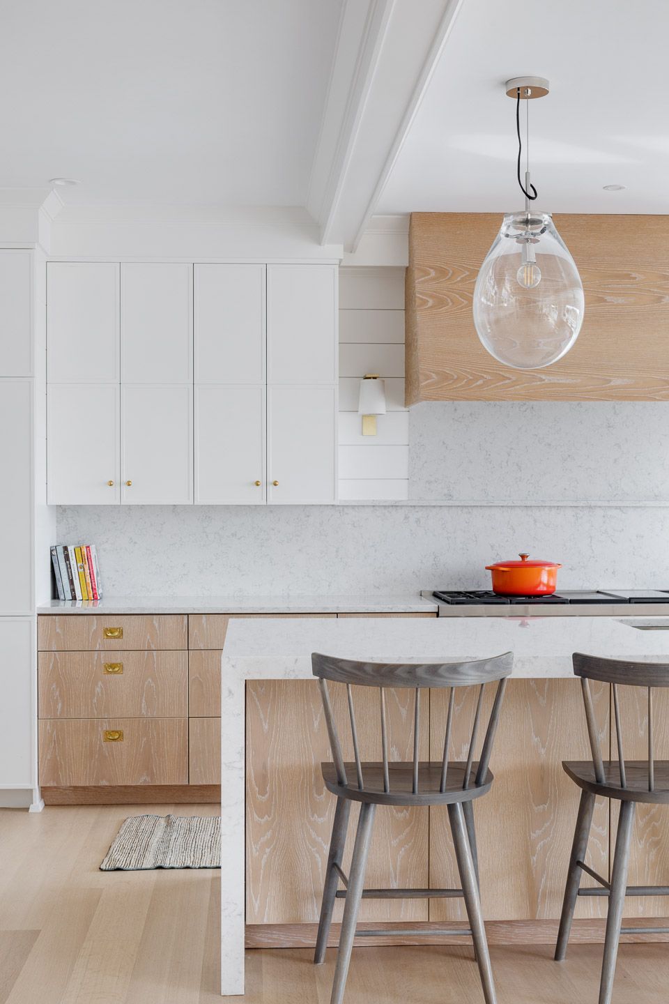 Kitchen detail cabinets with island and clear glass pendant light