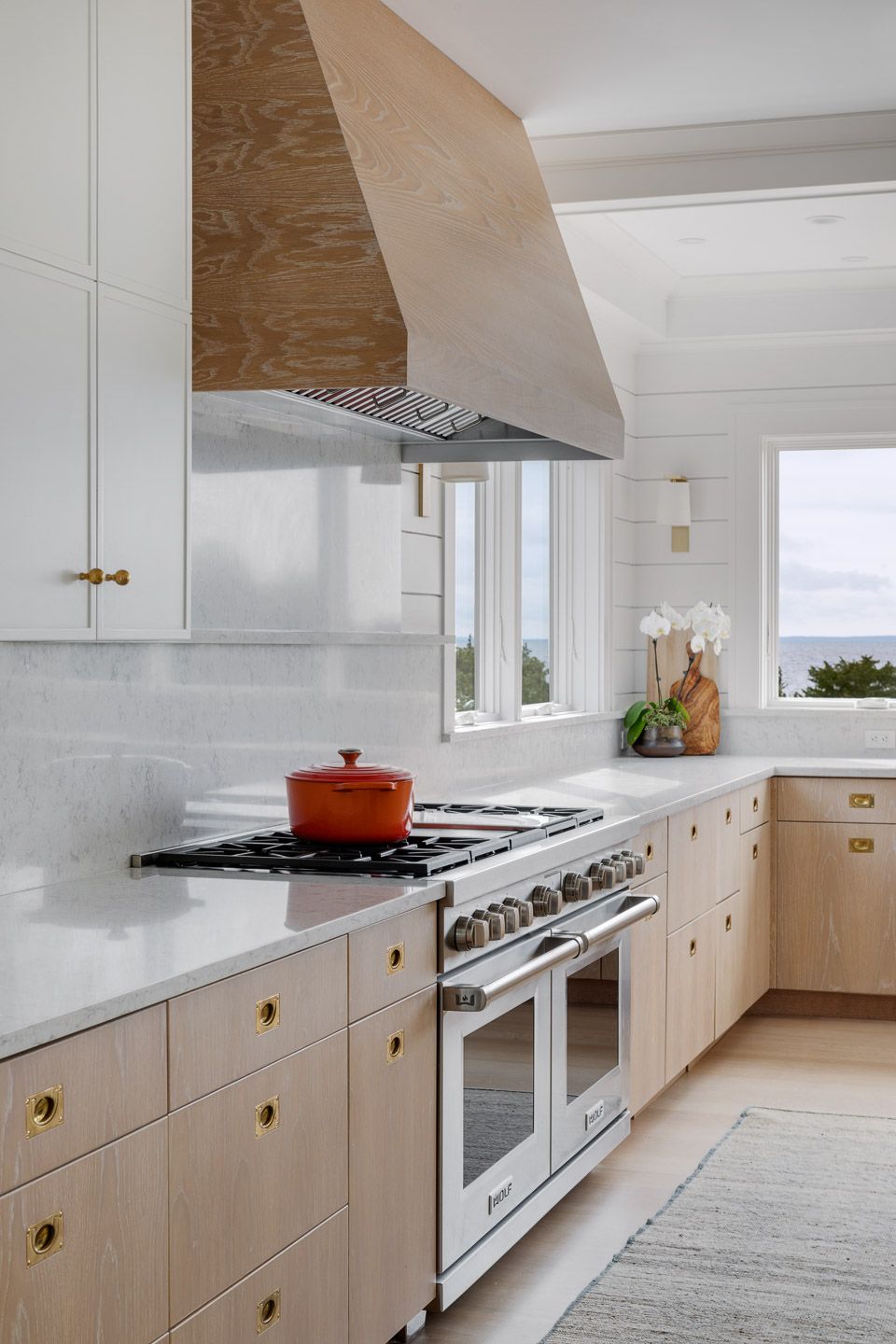 Kitchen detail cooking range and natural wood hood