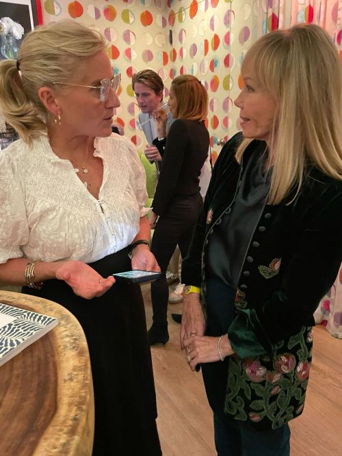 Two women talking at a design party
