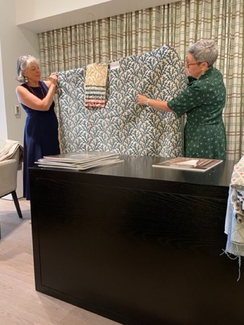 Two women present English textiles