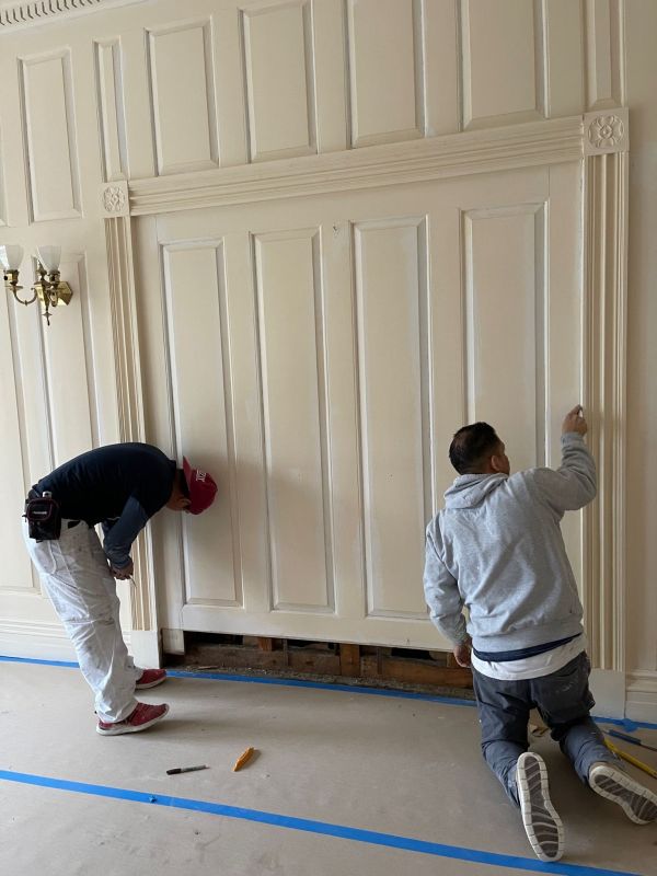 Carpenters remove side casing from pocket door