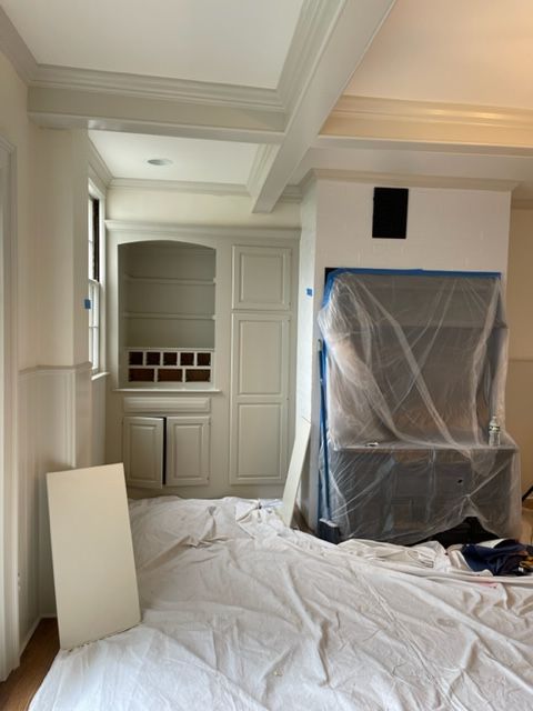 Kitchen being painted with old stove protected