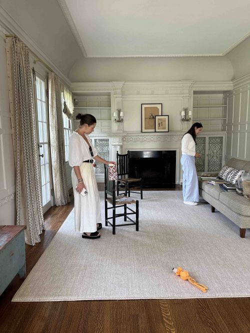 Two women oversee furniture install